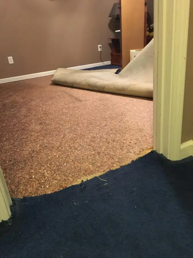 Carpet pad removal revealing water damage during Water Mitigation Services in Napili-Honokowai